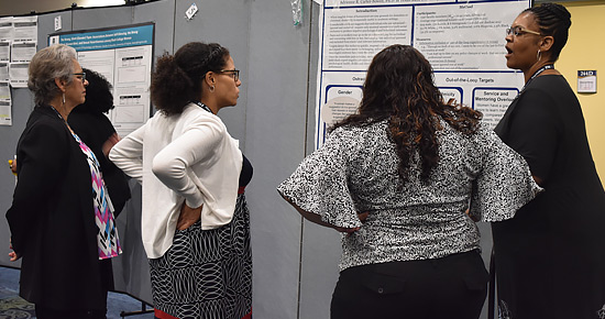 Institute participants discuss research at the opening day poster session.