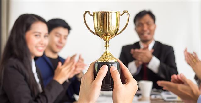 A woman recieving an award at a podium