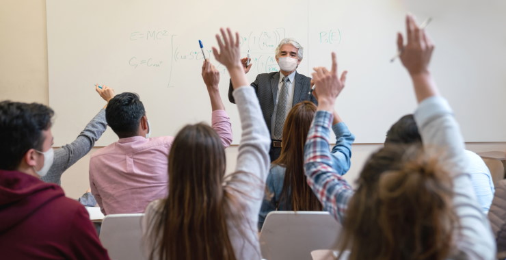 hands raised in a classroom