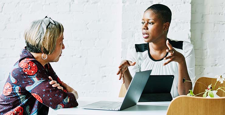 Two women talking in an office