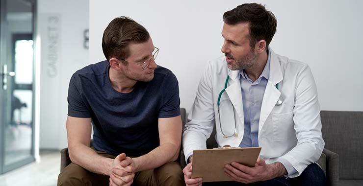 A man talking with a physician.