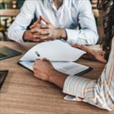 people at a table reviewing paperwork