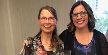Kristi Phillips (right) celebrates as Katherine M. Slaina, PhD, receives the 2019 Excellence in Rural Psychology Awards.