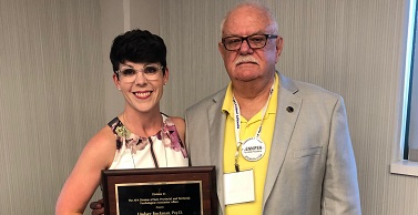 Lindsey Buckman, PsyD, receives the Outstanding Psychologist Award from Bruce Nystrom, PhD. 