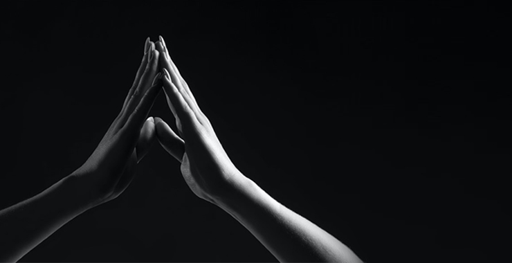a hand touching a mirror, being reflected