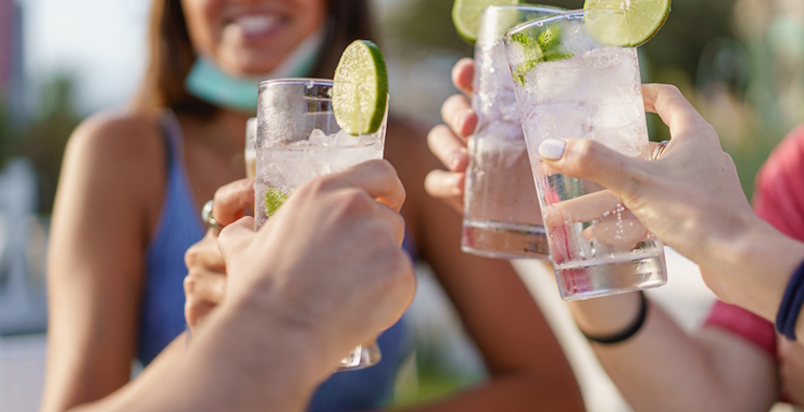 People toasting summer drinks.