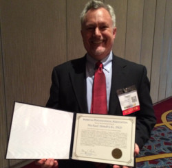 Dr. Michael Hendricks receives a presidential citation.