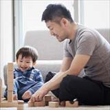 Father and toddler son playing with blocks