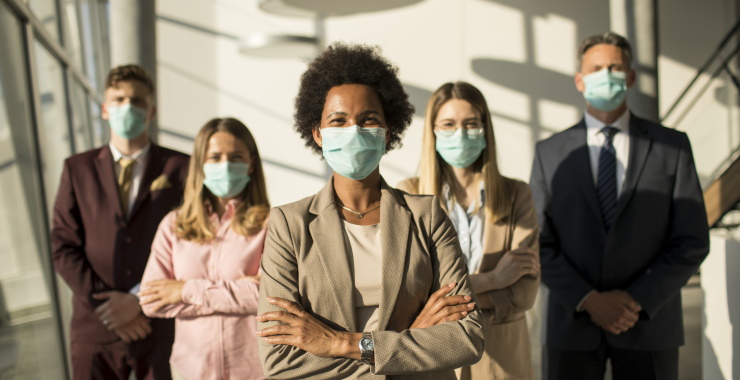 Business professionals, smiling, masked