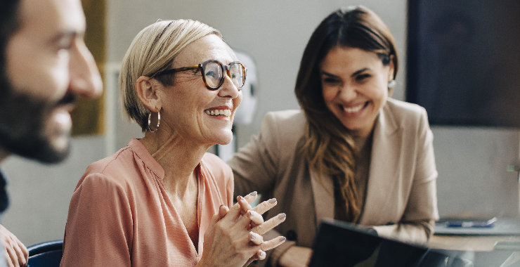 women laughing in a business meeting