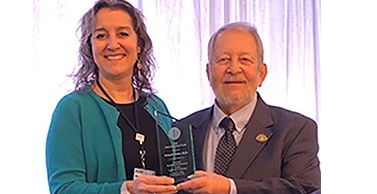 Michelle McKinne, PsyD, awarding to Kenneth Bohm, PhD