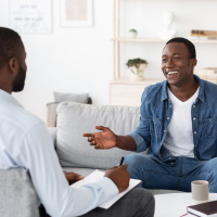 man relaxed, talking from a sofa