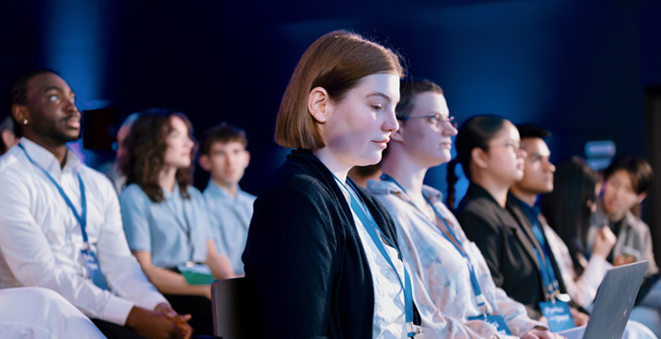 people sitting at a conference session