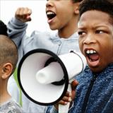 Black boys yelling into a megaphone