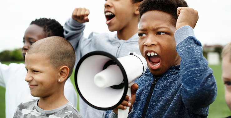 Black boys yelling into a megaphone