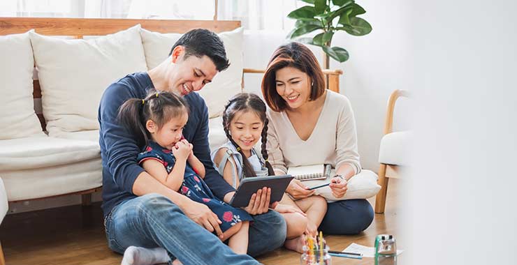 parents and children sitting on the floor together