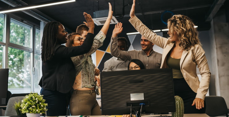 Work group high-fiving each other