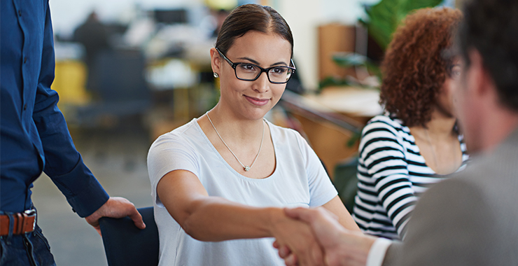 Woman wearing classes shaking hands
