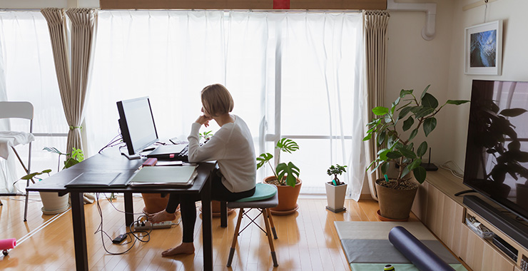 woman at a desk in front of a computer