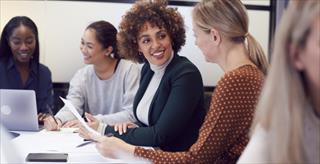 group of women working around a large table