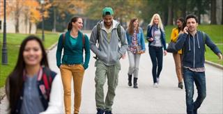 Graduate students walking through a park.