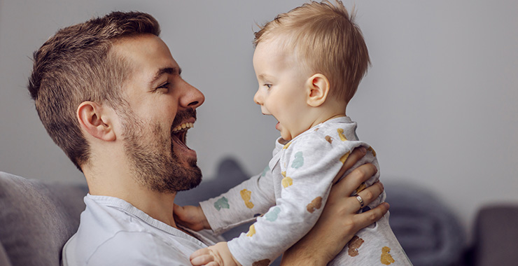 Dad and baby both laughing
