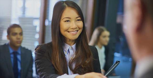 Young minority professional shaking hands with employer 