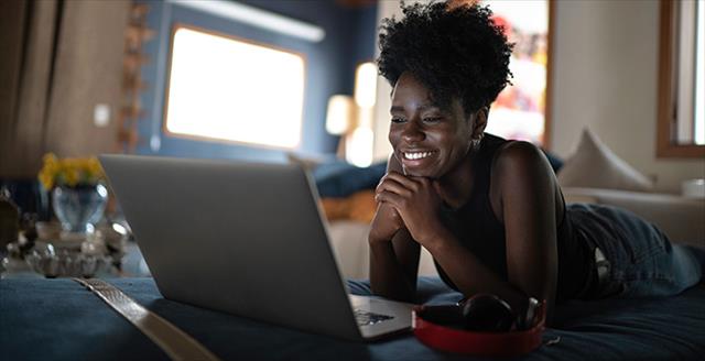 black woman smiling into computer